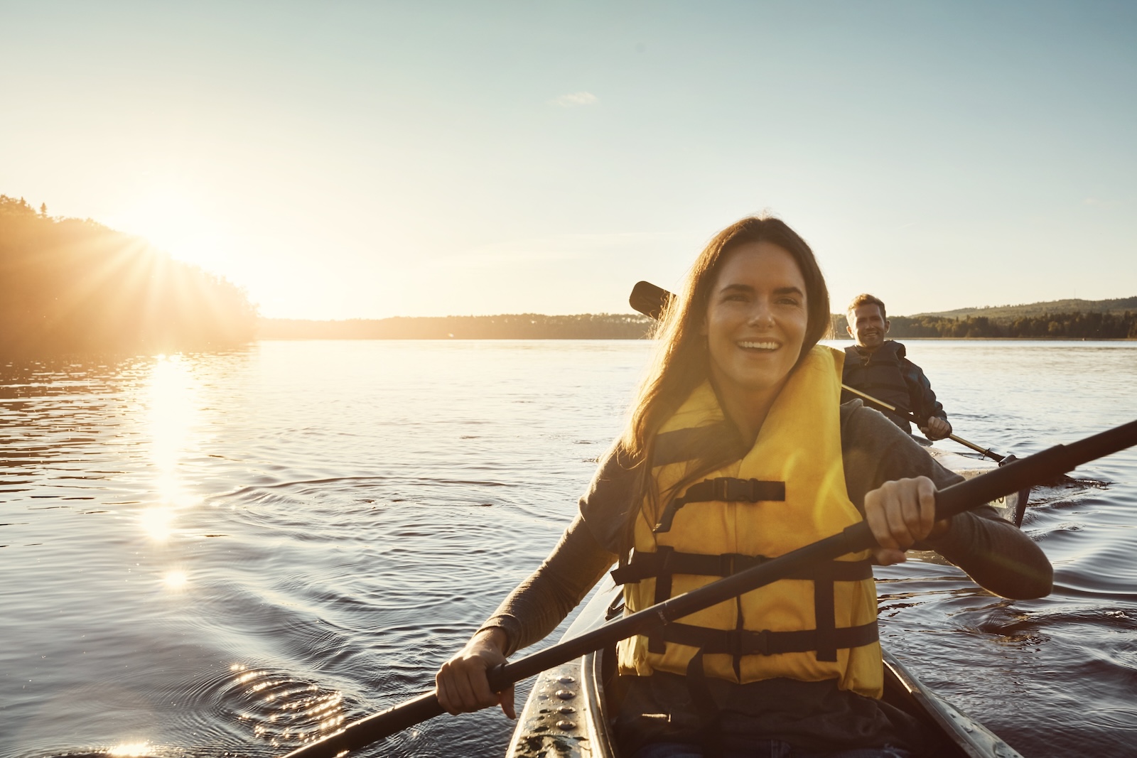 Happy couple kayaking on the glassy waters of Mirror Lake State Park in Wisconsin 