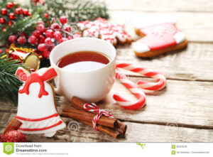 Christmas tea with cookies, cinnamon sticks and cany cane